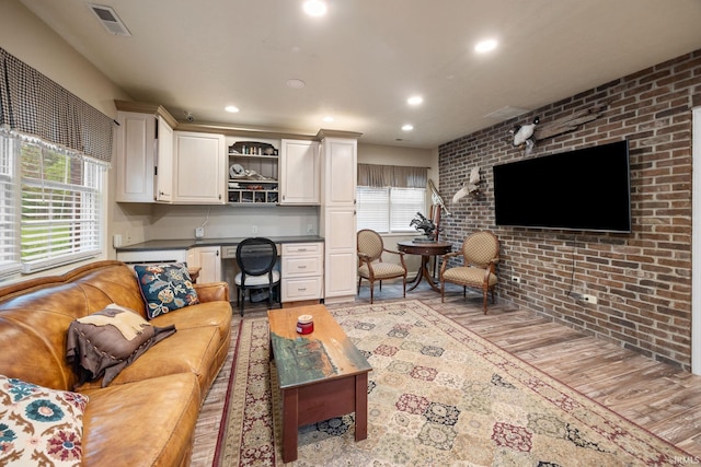 2525 Hastye Hyll, Logansport, IN 46947 - living room featuring light wood-style floors, plenty of natural light, built in desk, recessed lighting, and brick wall