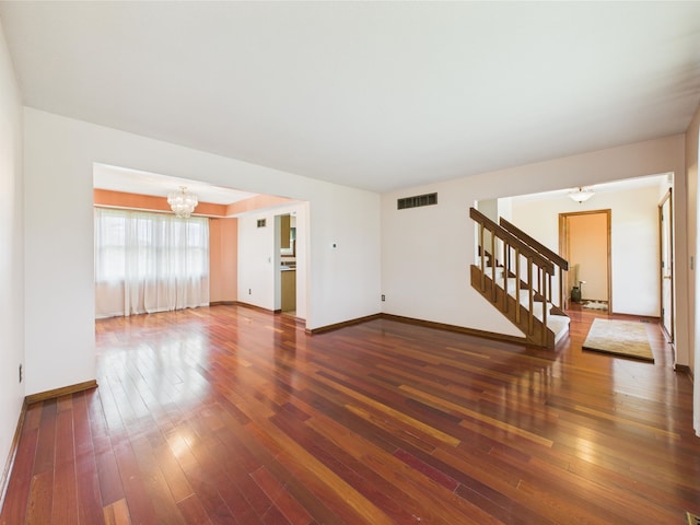 3715 W 630 Rd N, Huntington, IN 46750 - unfurnished living room featuring a chandelier, stairway, hardwood / wood-style floors, and baseboards