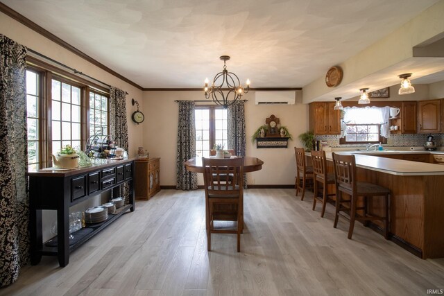 6497 N 500 E, Union City, IN 47390 - dining space featuring an AC wall unit, light wood-type flooring, plenty of natural light, and a chandelier