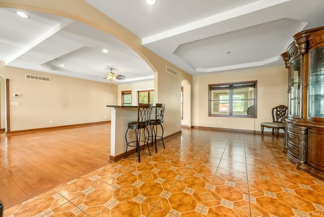 2395 S 400 St W, Warsaw, IN 46580 - living room with a tray ceiling, arched walkways, recessed lighting, ceiling fan, and baseboards