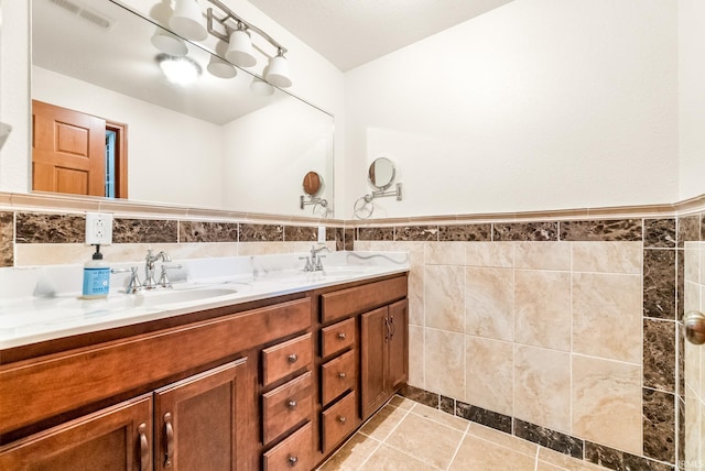 2395 S 400 St W, Warsaw, IN 46580 - full bath with double vanity, tile walls, wainscoting, and tile patterned flooring