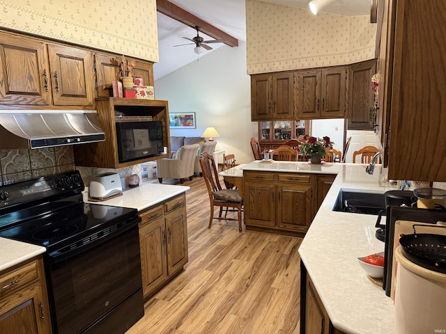 2807 Avondale Rd, Vincennes, IN 47591 - kitchen with black appliances, under cabinet range hood, ceiling fan, light wood-style flooring, and light countertops