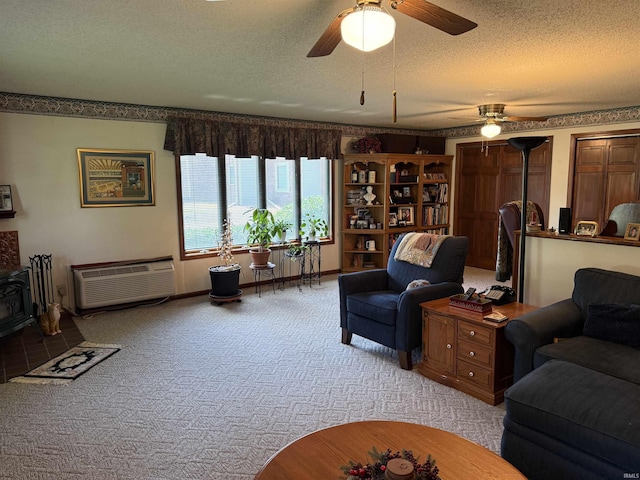 2807 Avondale Rd, Vincennes, IN 47591 - living room featuring a textured ceiling, ceiling fan, a wall mounted AC, a wood stove, and light carpet