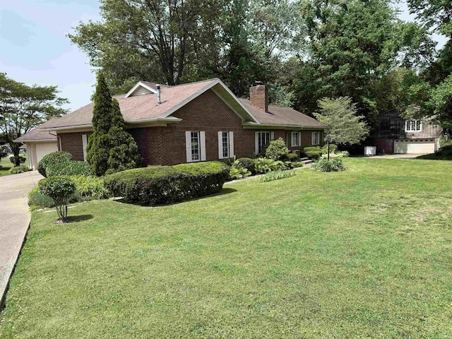 2807 Avondale Rd, Vincennes, IN 47591 - ranch-style house with a chimney, brick siding, a front yard, and concrete driveway