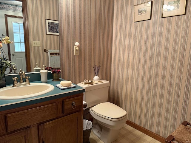 2807 Avondale Rd, Vincennes, IN 47591 - bathroom with vanity, toilet, baseboards, and wallpapered walls