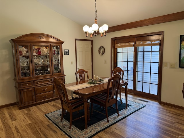 2807 Avondale Rd, Vincennes, IN 47591 - dining room featuring a chandelier, light wood-style flooring, baseboards, and lofted ceiling