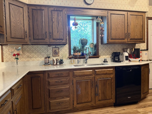 2807 Avondale Rd, Vincennes, IN 47591 - kitchen with black dishwasher, a sink, decorative backsplash, light countertops, and light wood-style flooring