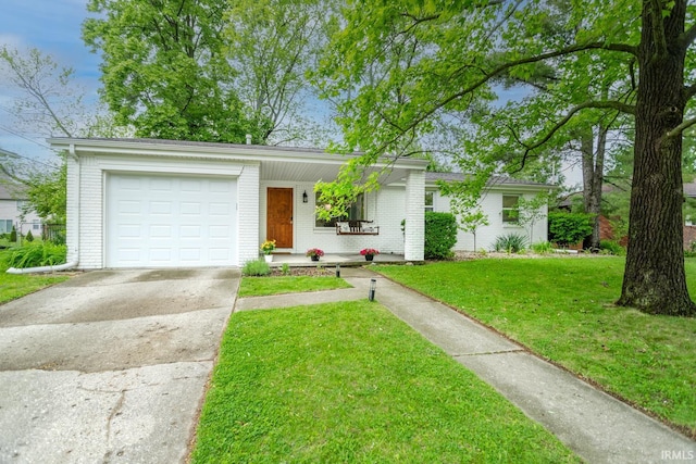 704 Avondale St, West Lafayette, IN 47906 - view of front of house featuring brick siding, concrete driveway, an attached garage, and a front lawn