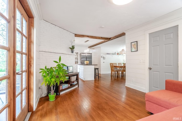 704 Avondale St, West Lafayette, IN 47906 - living room featuring wood finished floors and brick wall