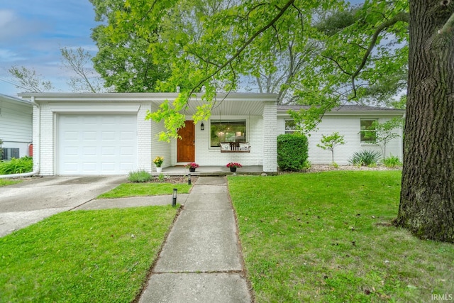 704 Avondale St, West Lafayette, IN 47906 - mid-century home with brick siding, concrete driveway, a front lawn, and a garage
