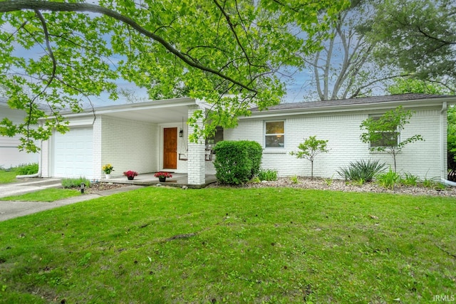 704 Avondale St, West Lafayette, IN 47906 - view of front of property featuring brick siding, a front yard, an attached garage, and driveway