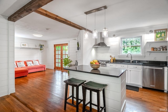 704 Avondale St, West Lafayette, IN 47906 - kitchen with stainless steel appliances, wall chimney exhaust hood, a sink, beamed ceiling, and healthy amount of natural light