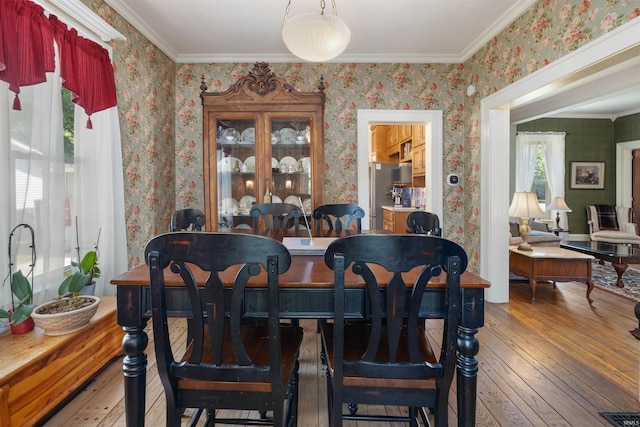702 S Van Buren St, Auburn, IN 46706 - dining area featuring wallpapered walls, wood-type flooring, and ornamental molding