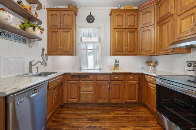 702 S Van Buren St, Auburn, IN 46706 - kitchen featuring stainless steel appliances, a sink, dark wood-type flooring, light countertops, and brown cabinets