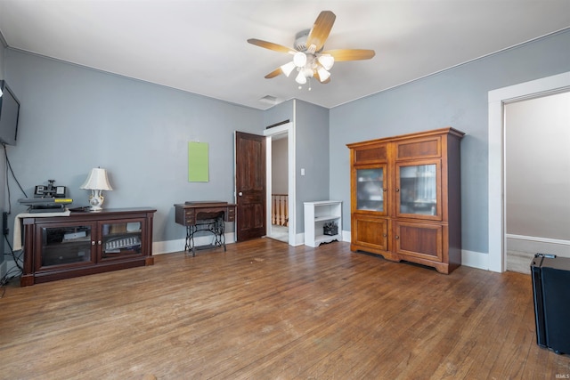 702 S Van Buren St, Auburn, IN 46706 - living area with ceiling fan, wood finished floors, and baseboards