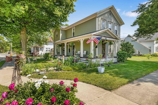 702 S Van Buren St, Auburn, IN 46706 - victorian house featuring covered porch and a front lawn