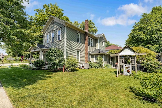 702 S Van Buren St, Auburn, IN 46706 - view of front of house with a chimney, a front lawn, and central AC unit