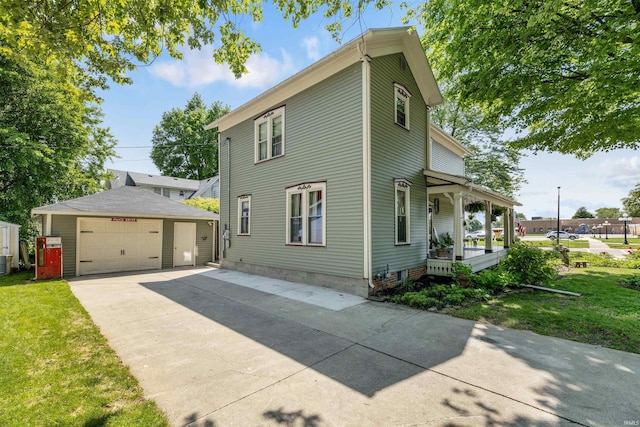 702 S Van Buren St, Auburn, IN 46706 - view of front facade featuring an outbuilding, a porch, a detached garage, a front lawn, and driveway
