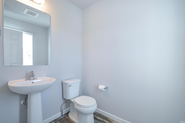 409 W Somerfield Dr, Lakeville, IN 46536 - half bath featuring toilet, wood finished floors, baseboards, and a sink