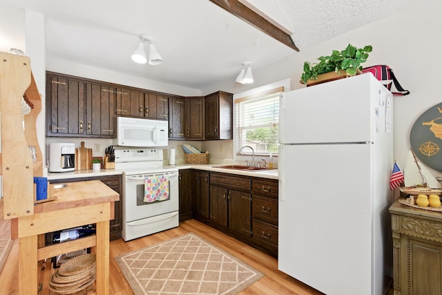 5585 S 930 E, Wolcottville, IN 46795 - kitchen featuring white appliances, a sink, dark brown cabinets, and light countertops