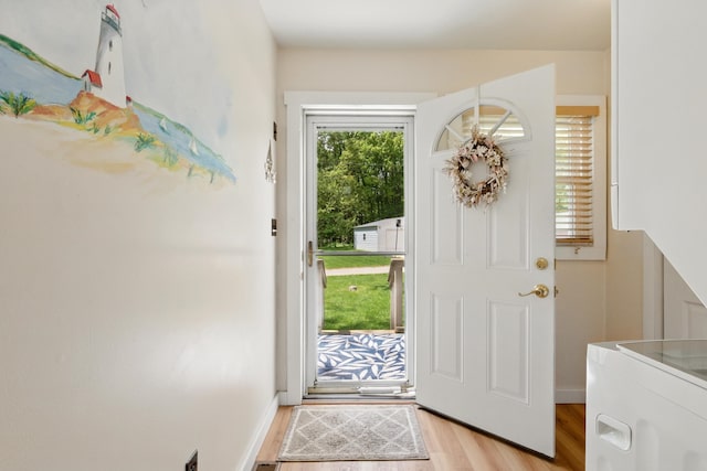 5585 S 930 E, Wolcottville, IN 46795 - foyer entrance with light wood-style flooring, washer / clothes dryer, and baseboards