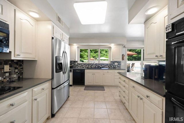 570 Golden Pl, Lafayette, IN 47905 - kitchen with black appliances, dark countertops, backsplash, and plenty of natural light