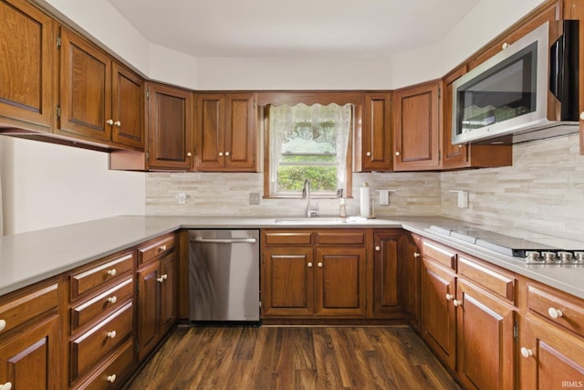 951 W Shepherds Ln, Santa Claus, IN 47579 - kitchen with appliances with stainless steel finishes, a sink, dark wood-type flooring, light countertops, and decorative backsplash