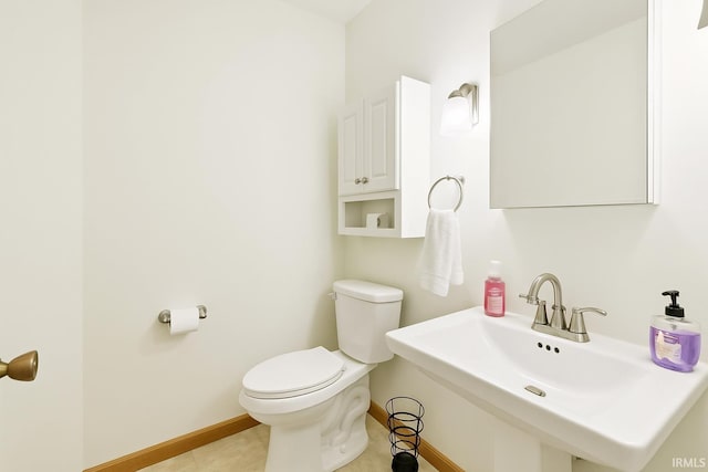 951 W Shepherds Ln, Santa Claus, IN 47579 - bathroom featuring toilet, baseboards, a sink, and tile patterned floors