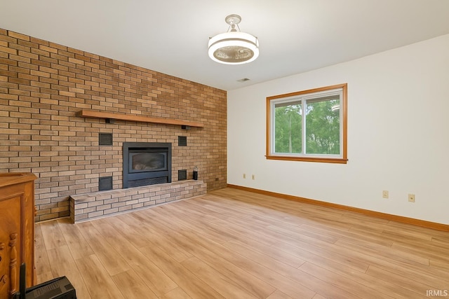 951 W Shepherds Ln, Santa Claus, IN 47579 - unfurnished living room featuring a fireplace, baseboards, and wood finished floors