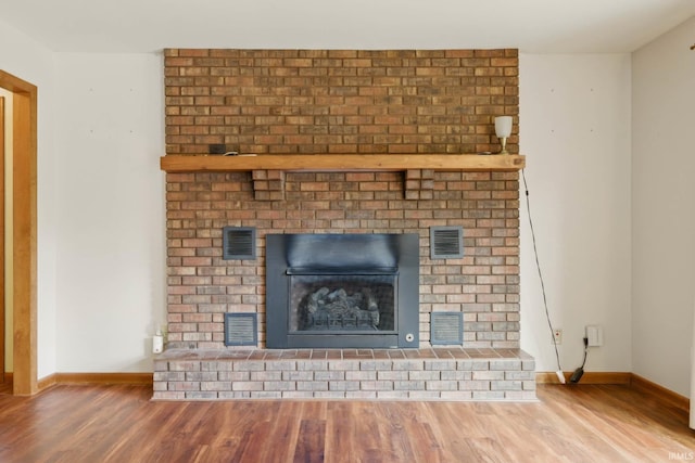 951 W Shepherds Ln, Santa Claus, IN 47579 - detailed view of wood finished floors, baseboards, and a brick fireplace