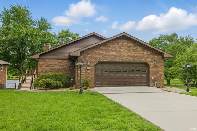 951 W Shepherds Ln, Santa Claus, IN 47579 - view of front of property featuring an attached garage, a chimney, concrete driveway, a front yard, and brick siding