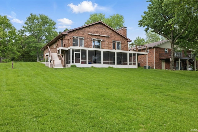 951 W Shepherds Ln, Santa Claus, IN 47579 - rear view of house featuring a sunroom, a chimney, a yard, and brick siding