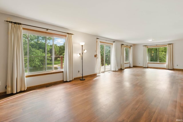 951 W Shepherds Ln, Santa Claus, IN 47579 - unfurnished living room featuring healthy amount of natural light, wood finished floors, and baseboards