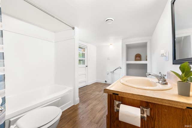 730 E Sherman St, Marion, IN 46952 - full bath with toilet, vanity, wood finished floors, baseboards, and washtub / shower combination