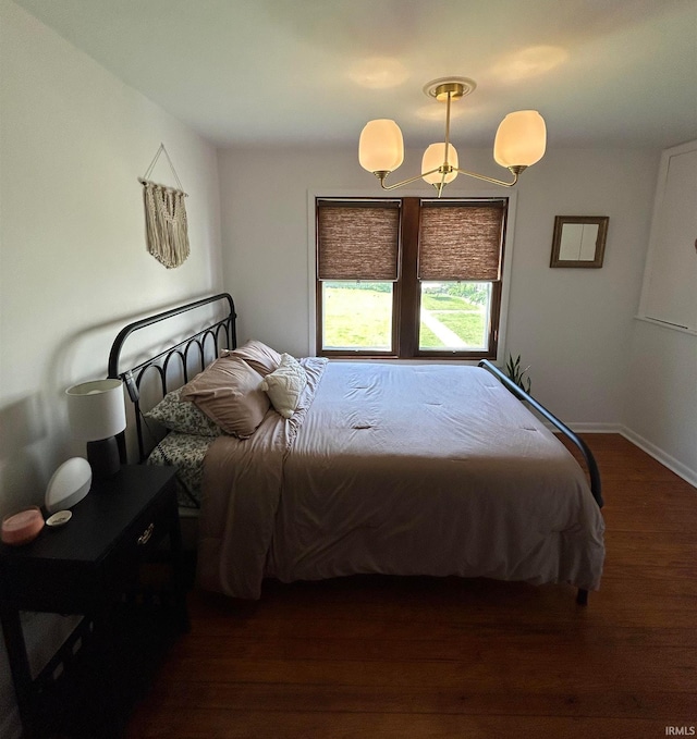 375 E Harrison Ave, Wabash, IN 46992 - bedroom featuring a chandelier, dark wood finished floors, and baseboards