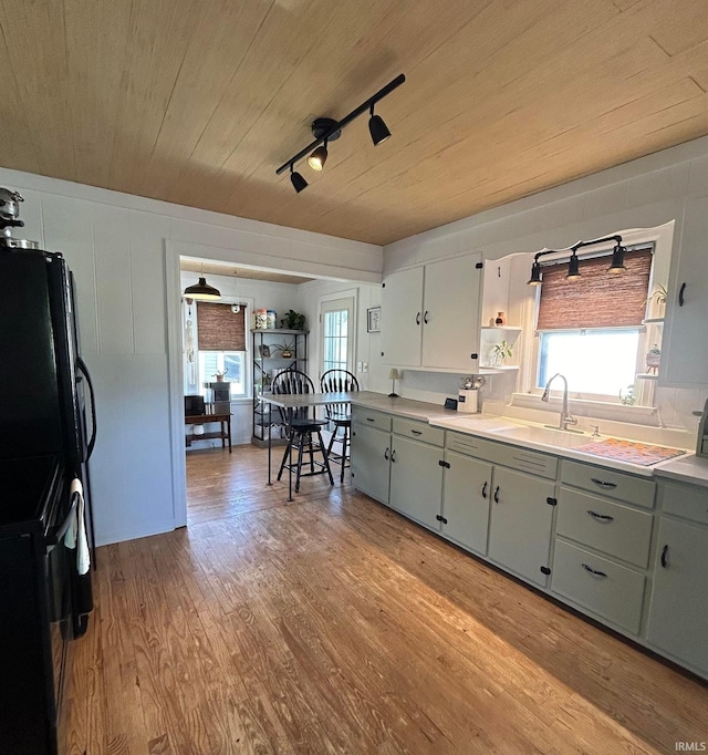 375 E Harrison Ave, Wabash, IN 46992 - kitchen featuring a sink, freestanding refrigerator, wood ceiling, healthy amount of natural light, and light wood-style floors