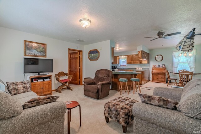 11542 S 700 E, Lafontaine, IN 46940 - living area with ceiling fan, light colored carpet, a textured ceiling, and baseboards