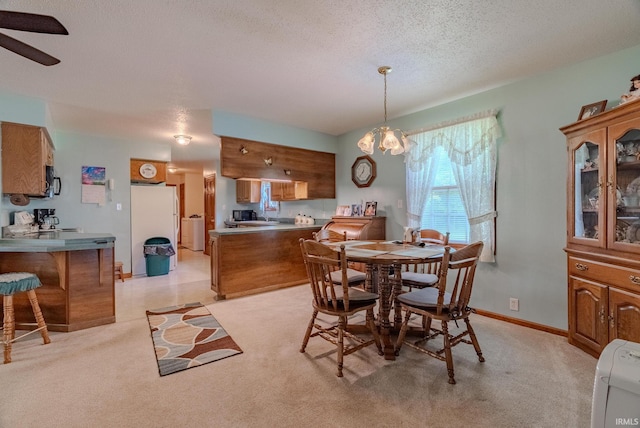 11542 S 700 E, Lafontaine, IN 46940 - dining area with a textured ceiling, a chandelier, ceiling fan, light carpet, and baseboards