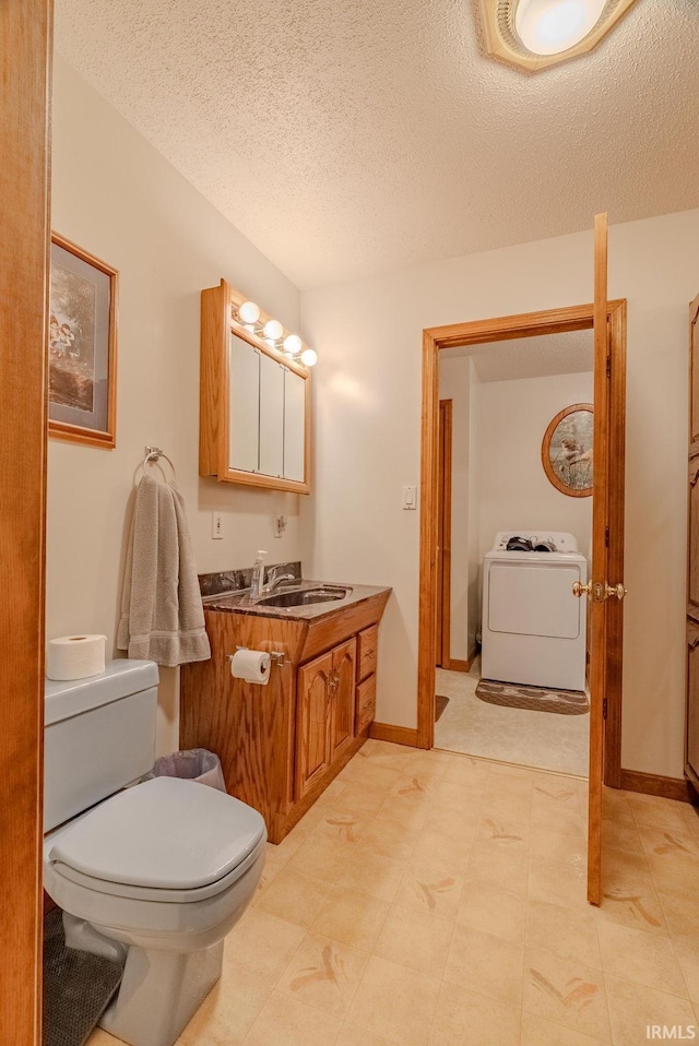 11542 S 700 E, Lafontaine, IN 46940 - bathroom with washer / clothes dryer, toilet, vanity, a textured ceiling, and tile patterned floors