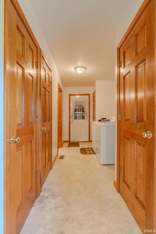 11542 S 700 E, Lafontaine, IN 46940 - corridor with washer and clothes dryer, light carpet, and a textured ceiling