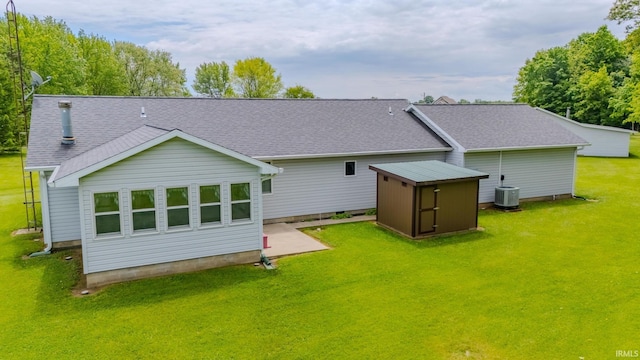 11542 S 700 E, Lafontaine, IN 46940 - rear view of property featuring central AC unit, a shingled roof, and a lawn