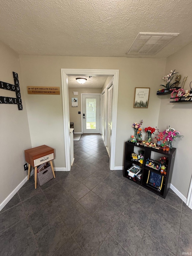 2782 W State Road 32nd Rd, Covington, IN 47932 - hall with baseboards, dark tile patterned floors, and a textured ceiling