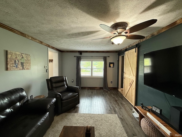2782 W State Road 32nd Rd, Covington, IN 47932 - living room with a barn door, a textured ceiling, hardwood / wood-style floors, ceiling fan, and crown molding