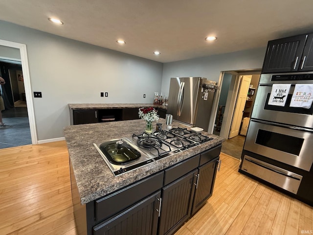 2782 W State Road 32nd Rd, Covington, IN 47932 - kitchen featuring appliances with stainless steel finishes, a warming drawer, light wood-style floors, recessed lighting, and a kitchen island