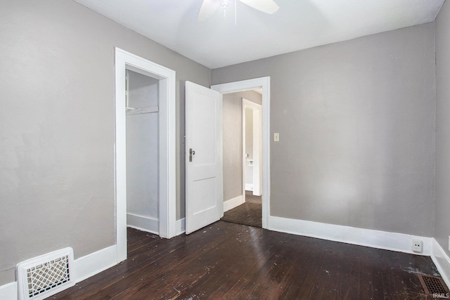 1130 N Kentucky St, South Bend, IN 46628 - unfurnished bedroom featuring hardwood / wood-style floors, baseboards, a ceiling fan, and a closet