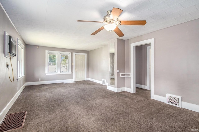 1130 N Kentucky St, South Bend, IN 46628 - carpeted spare room with a ceiling fan, baseboards, and a wall unit AC