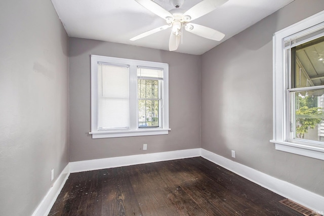 1130 N Kentucky St, South Bend, IN 46628 - empty room with dark wood-type flooring, baseboards, and a ceiling fan