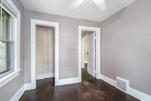 1130 N Kentucky St, South Bend, IN 46628 - unfurnished bedroom with hardwood / wood-style floors, baseboards, and a ceiling fan