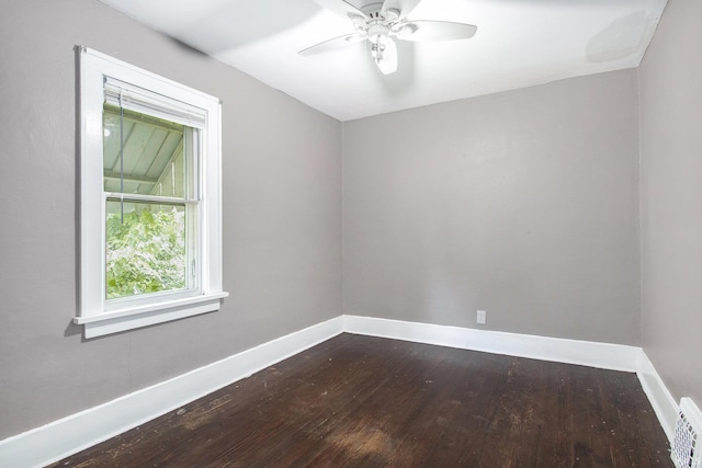 1130 N Kentucky St, South Bend, IN 46628 - spare room featuring dark wood finished floors, baseboards, and ceiling fan