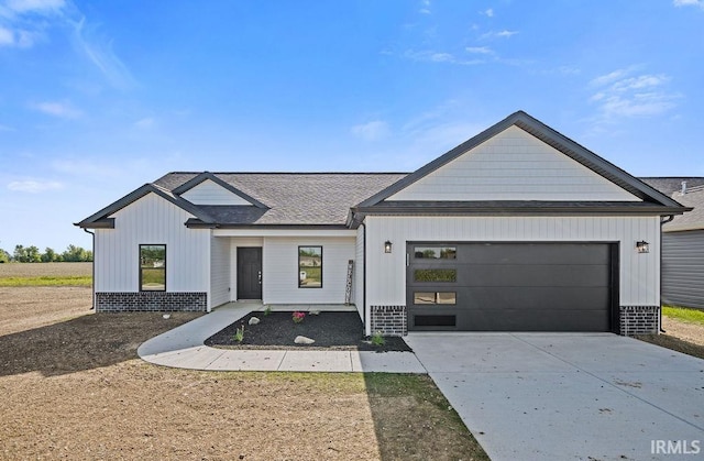 2487 Fiona Dr, Kokomo, IN 46902 - modern inspired farmhouse featuring concrete driveway, an attached garage, roof with shingles, and board and batten siding
